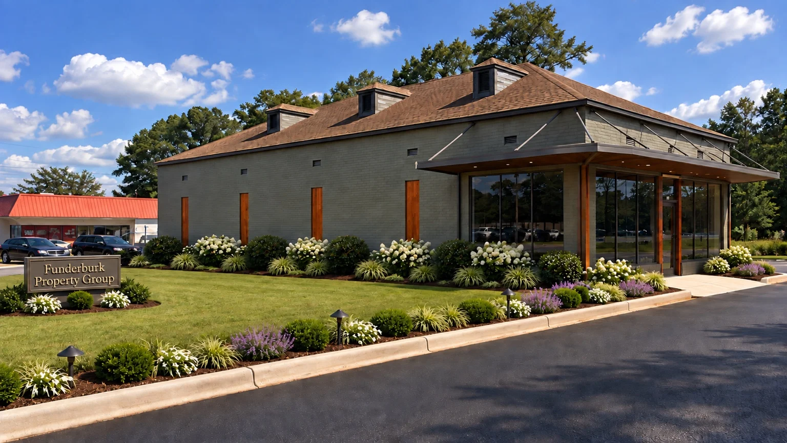 Digital concept rendering showing proposed office landscaping, planting beds, lawn, lighting and Funderburk Property Group signage